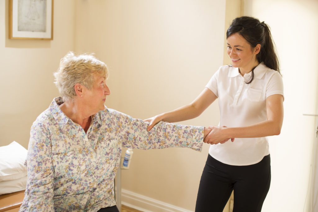 A senior woman receives physical therapy