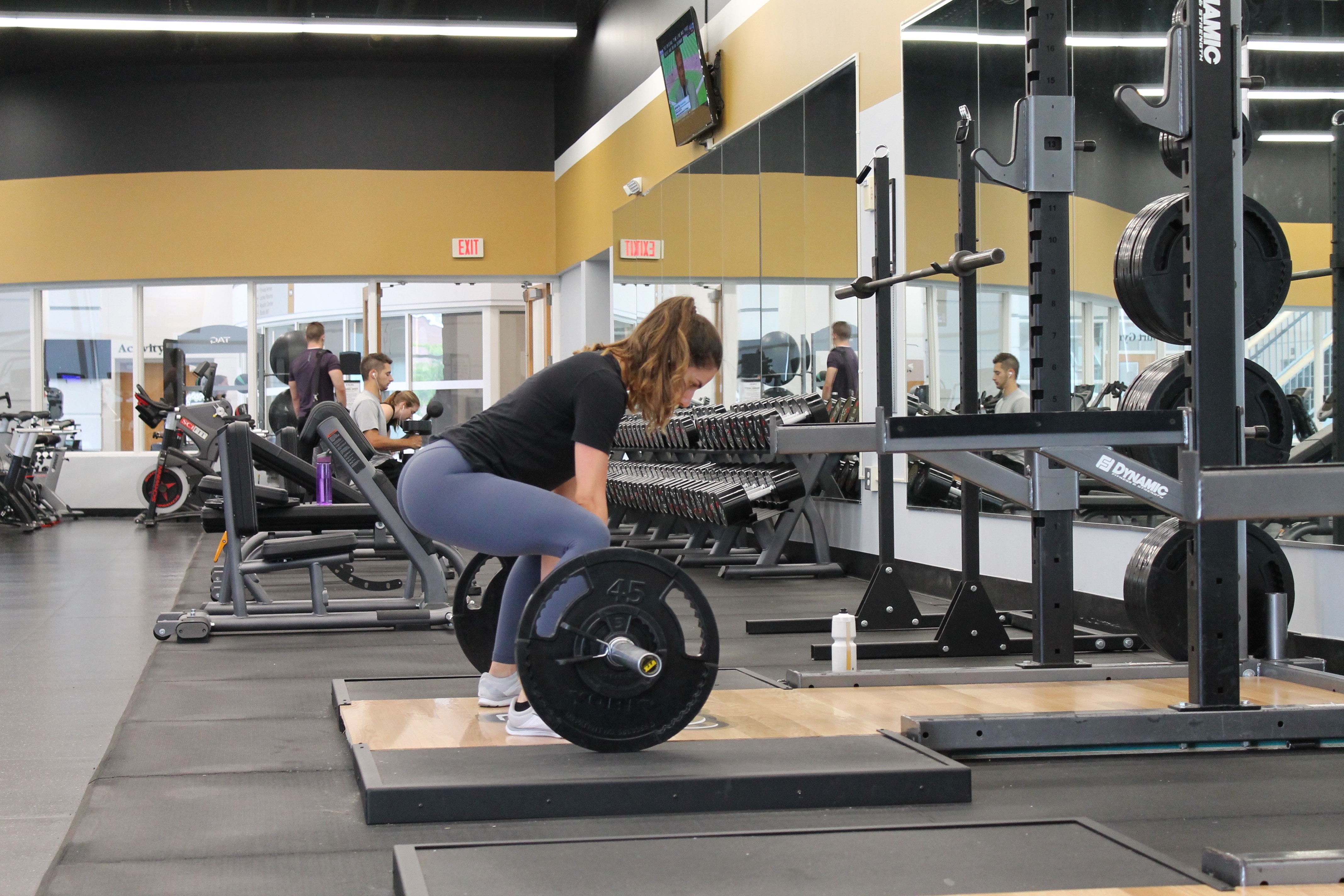 Woman lifting barbell at the gym
